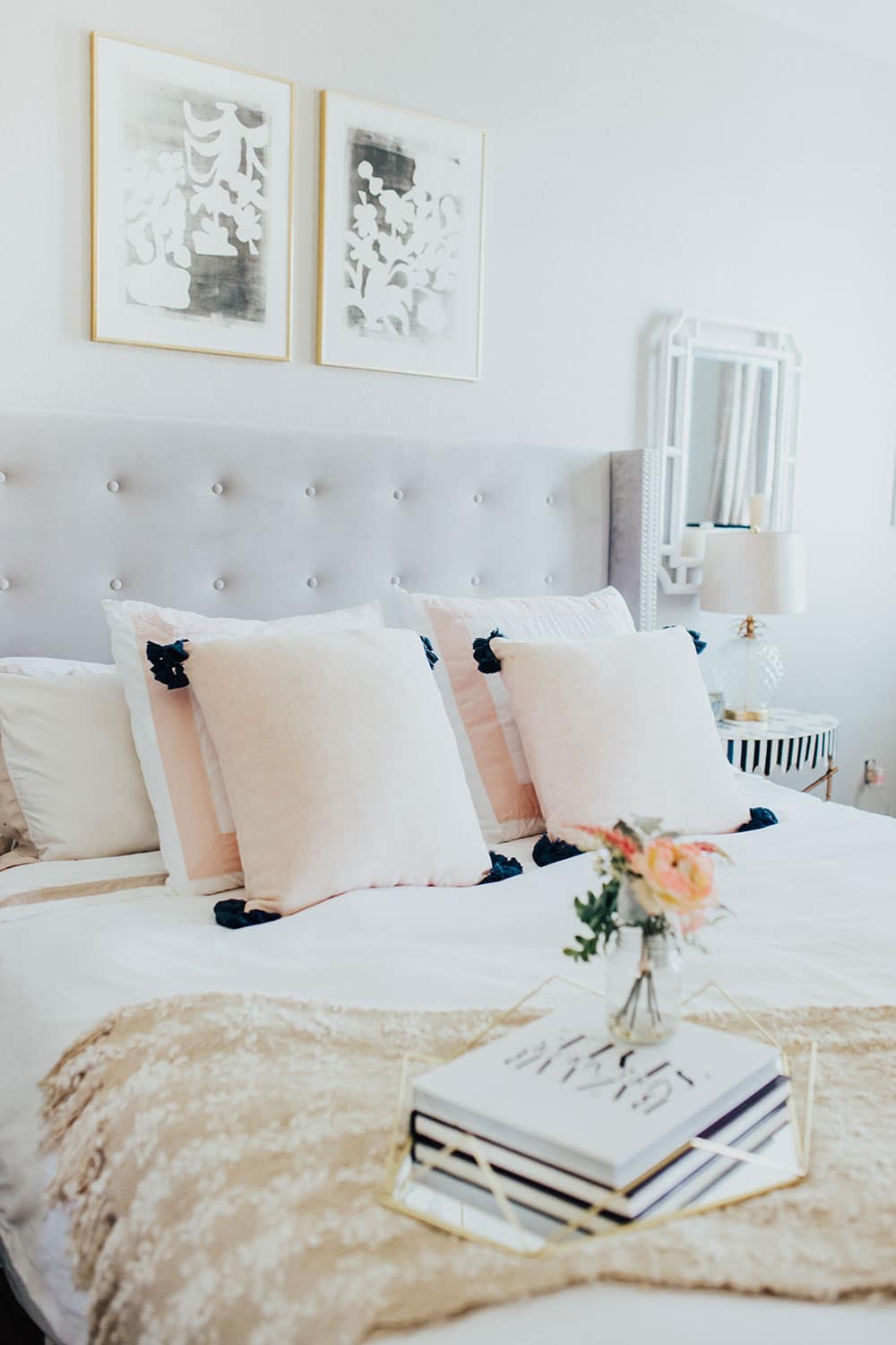 neutral farmhouse master bedroom ideas - white bedding with pink throw pillows
