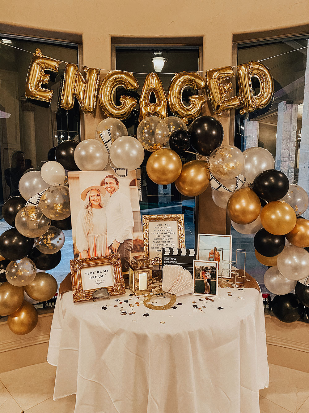 engagement party decor ideas - gold black and white balloon arch